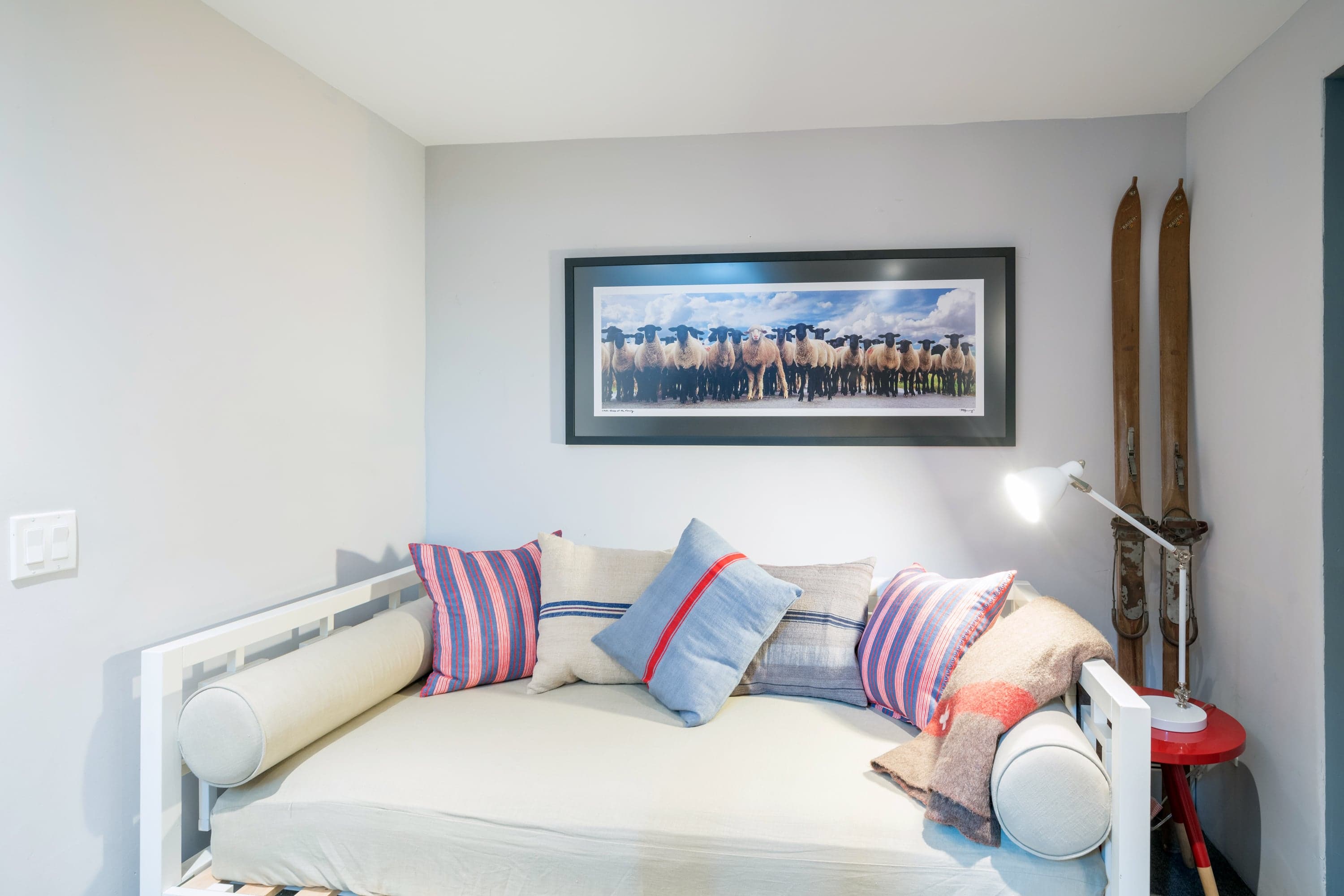 Couch beneath framed portrait.