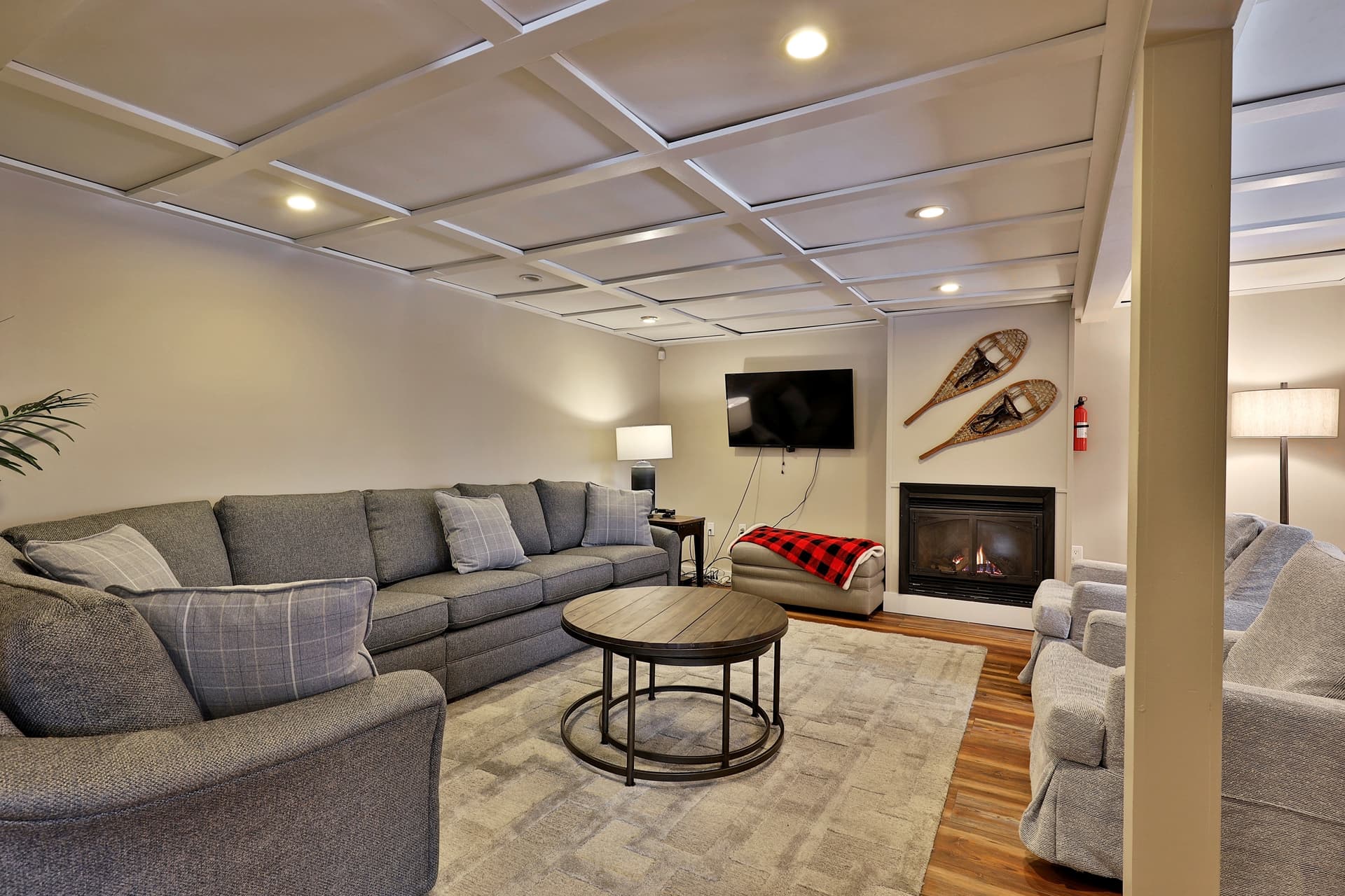 Beautiful downstairs living area with gas fireplace for ambiance and flat screen TV.