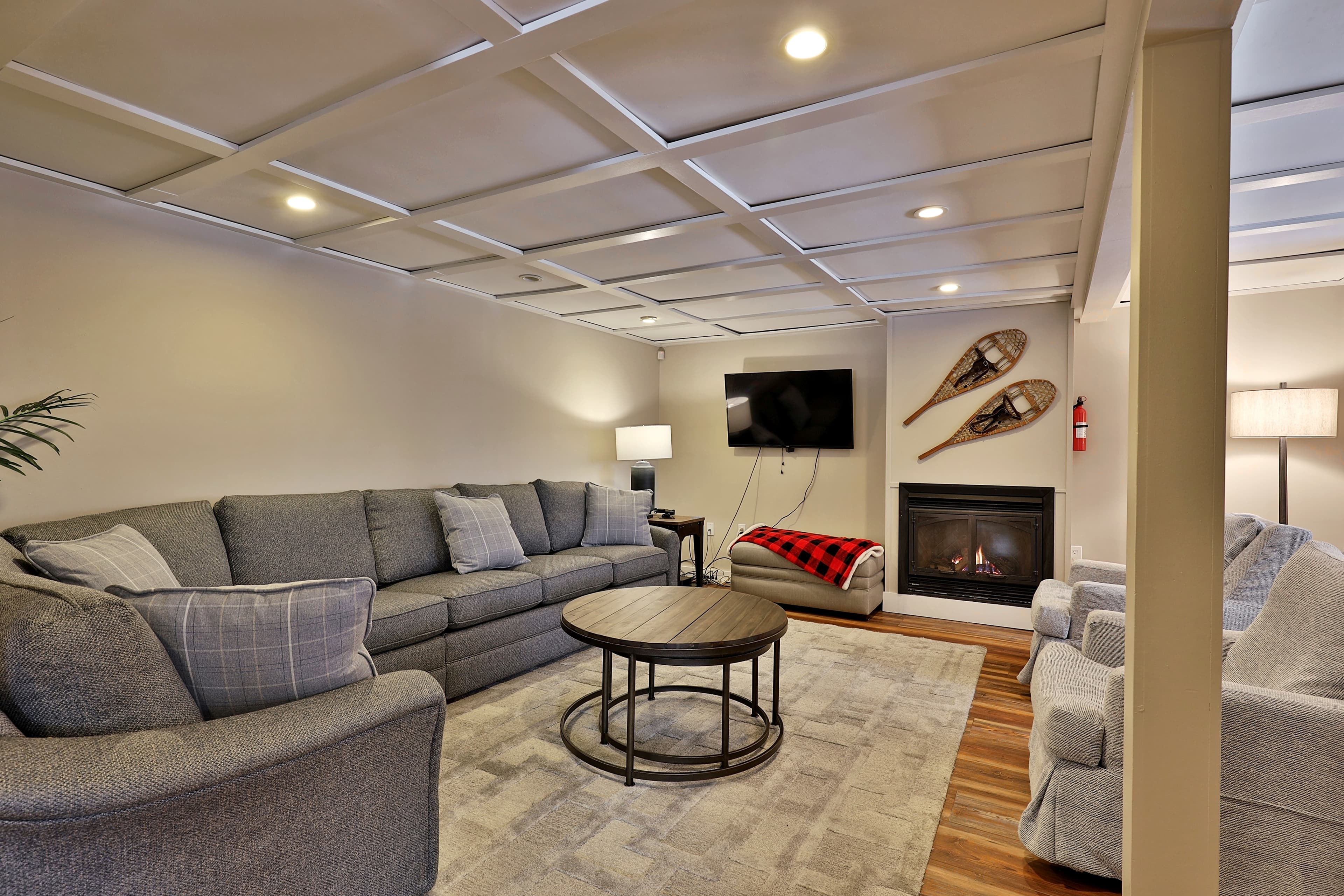 Beautiful downstairs living area with gas fireplace for ambiance and flat screen TV.