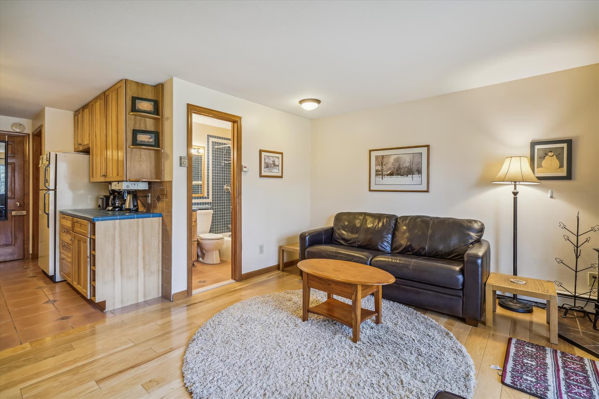 Living room with plenty of seating for your small group. Propane stove to enjoy and warm up after those cold days or just to add some ambiance to your evening. Tons of natural light from your slider door access to back yard and small patio.