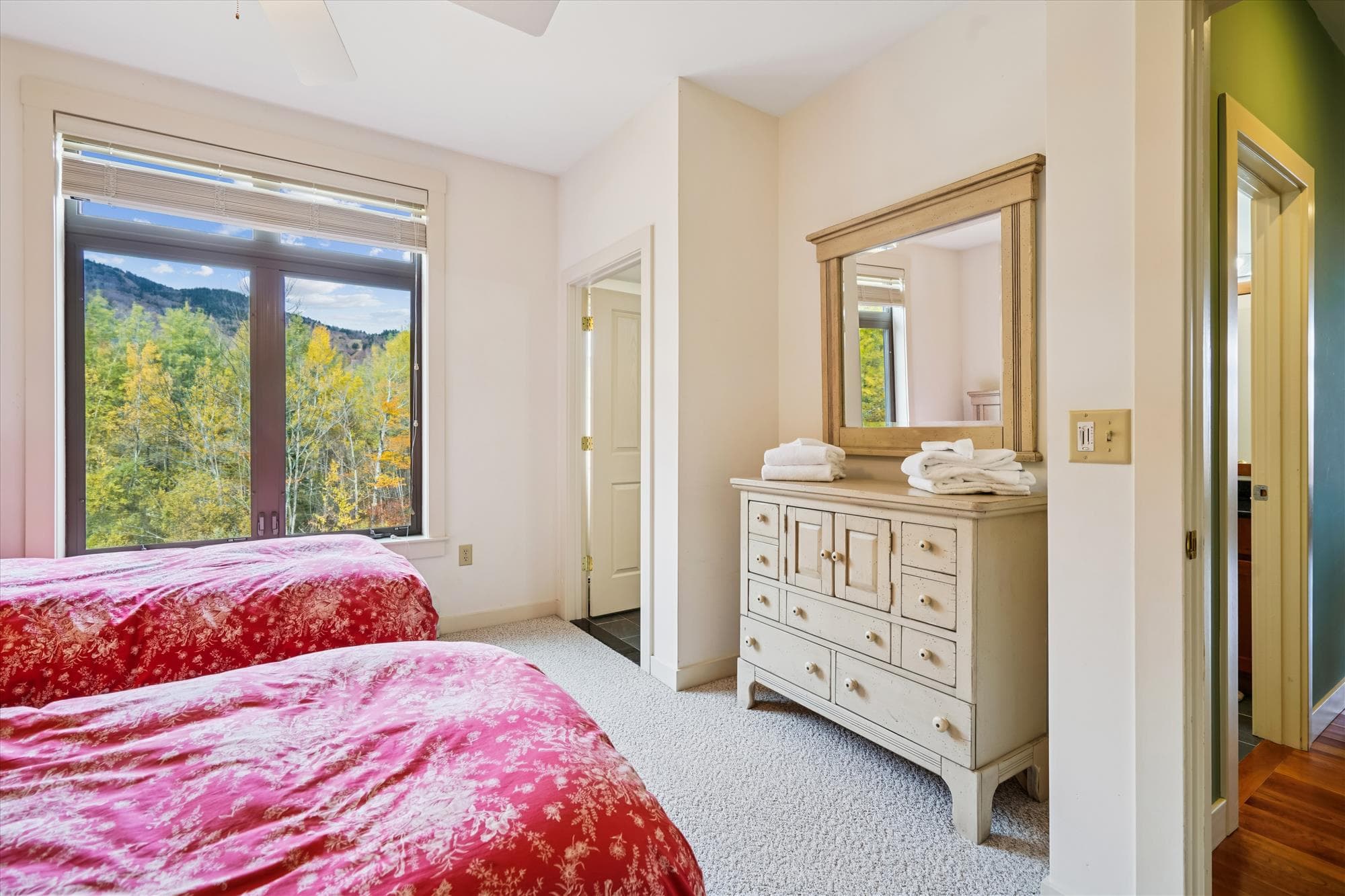 A favorite for families or friends, this cheerful bedroom offers two twin beds and a bunk set. Enjoy mountain views through the large window and plenty of space to unwind after a full day of Vermont adventure.