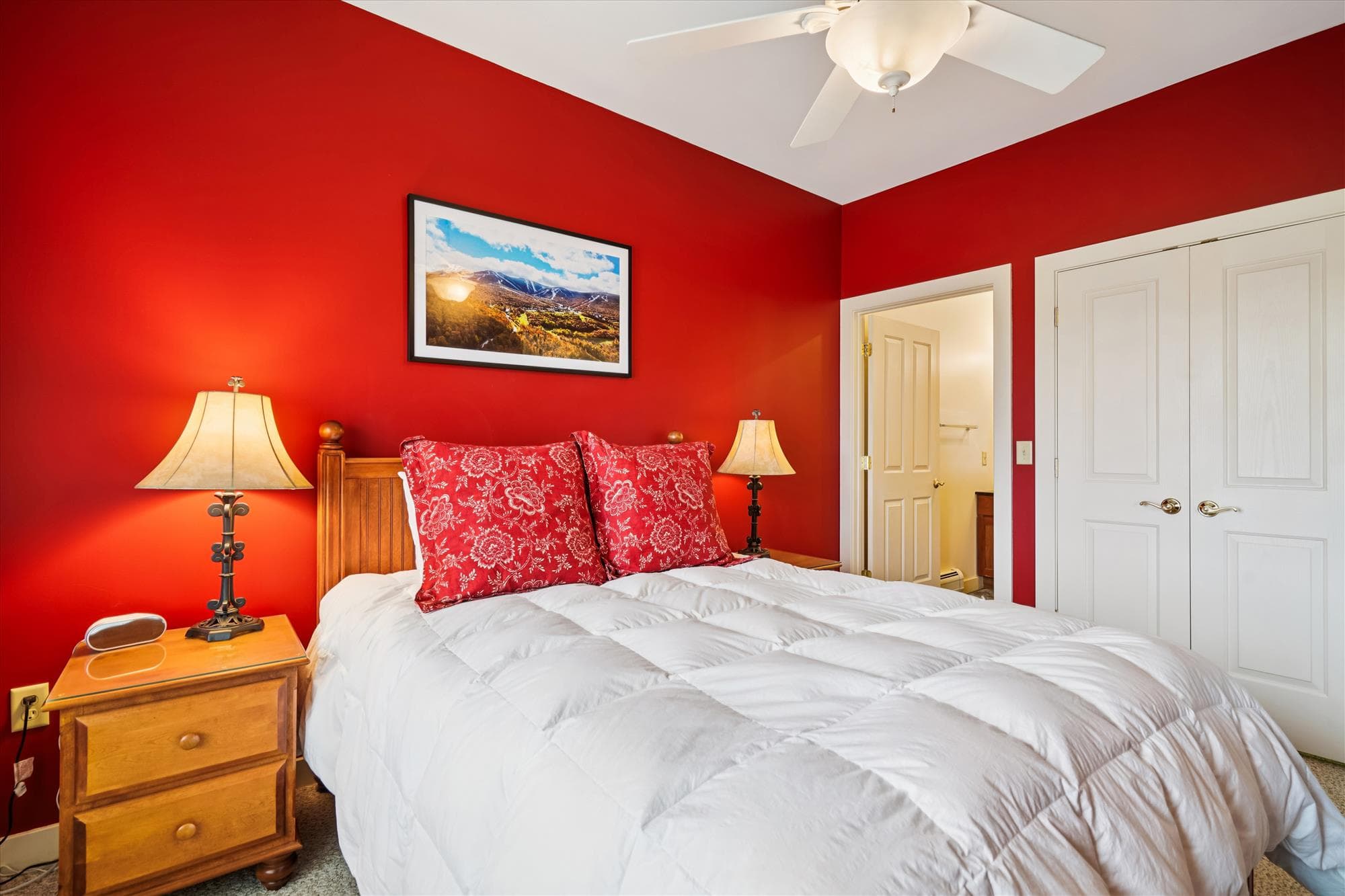 Queen bedroom with rich color, mountain views, and a private bathroom—perfect for guests who appreciate both comfort and privacy.