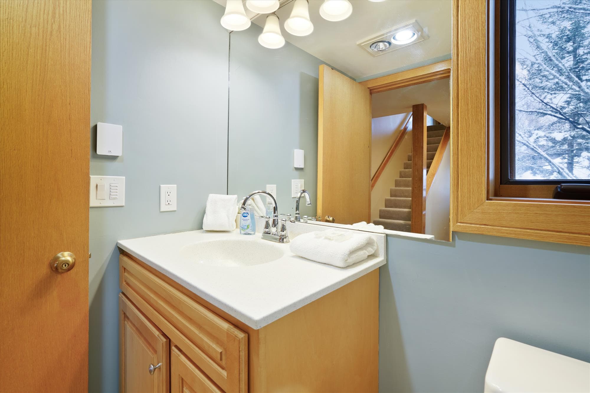 Full bathroom with vanity, mirror, and fresh towels provided for guests.