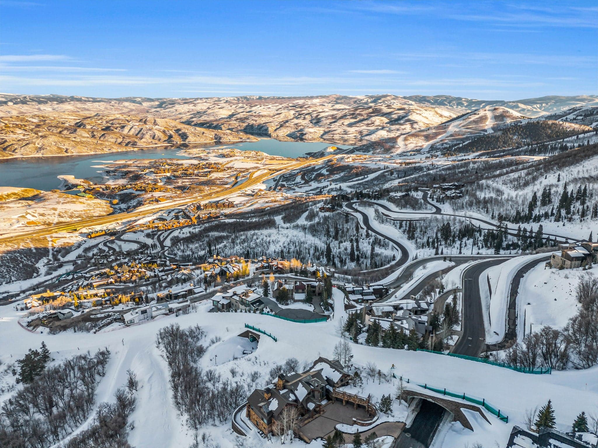 A distant, aerial view of the property, with roads winding through the snow all around it.