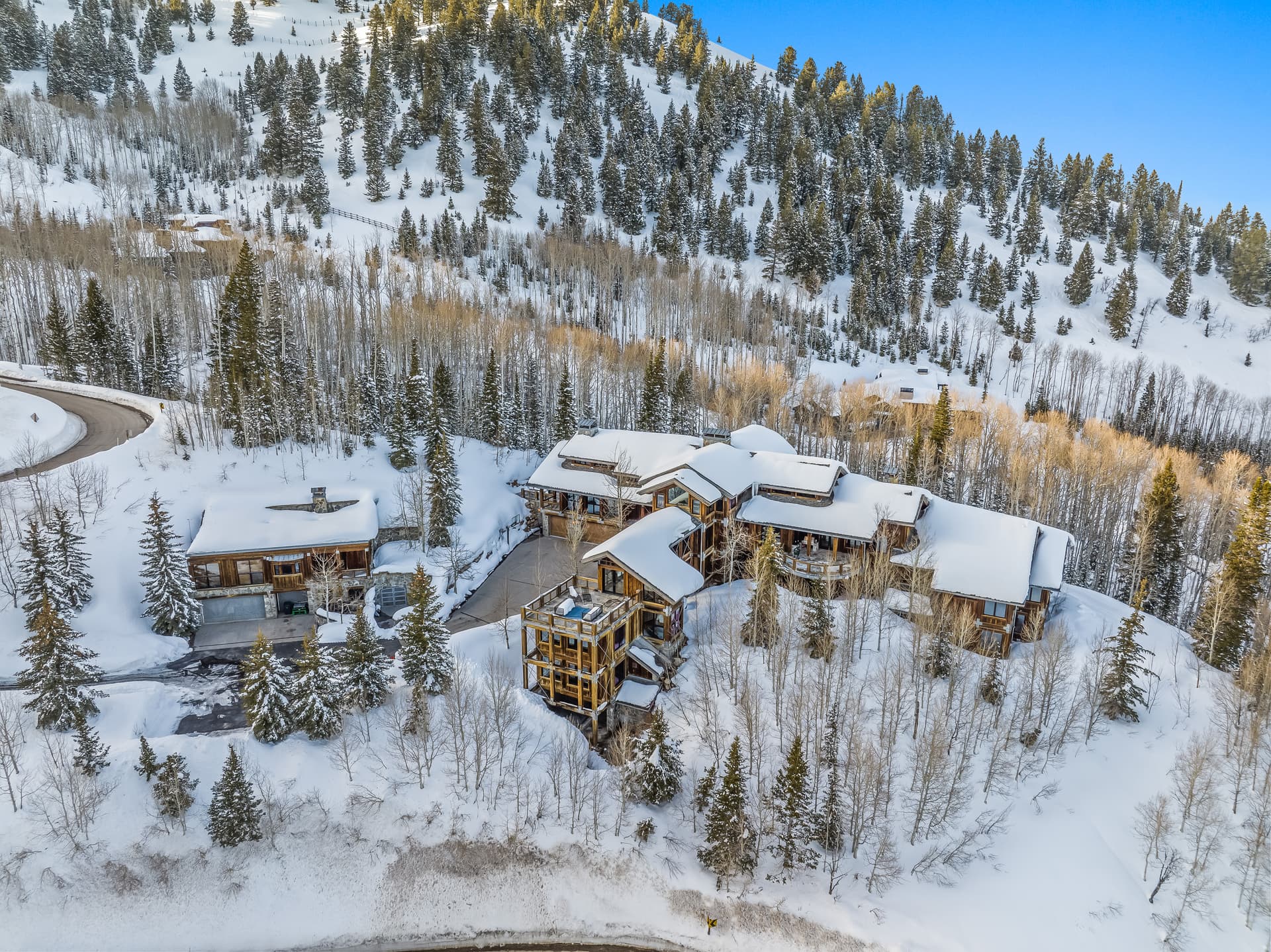 A distant aerial view of this luxury Park City vacation rental, showing off the surrounding forest.