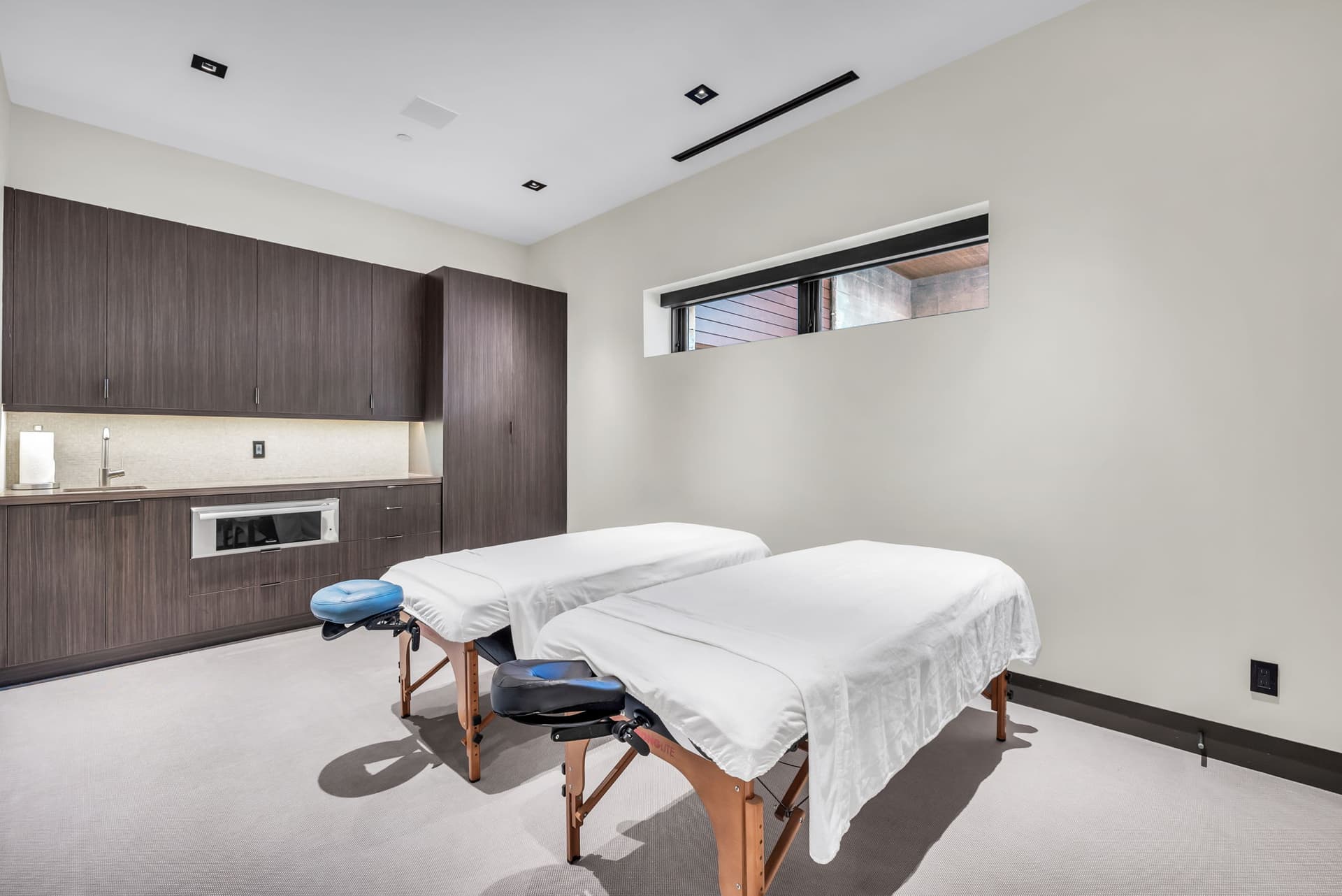 A relaxing  spa room with dual massage tables.