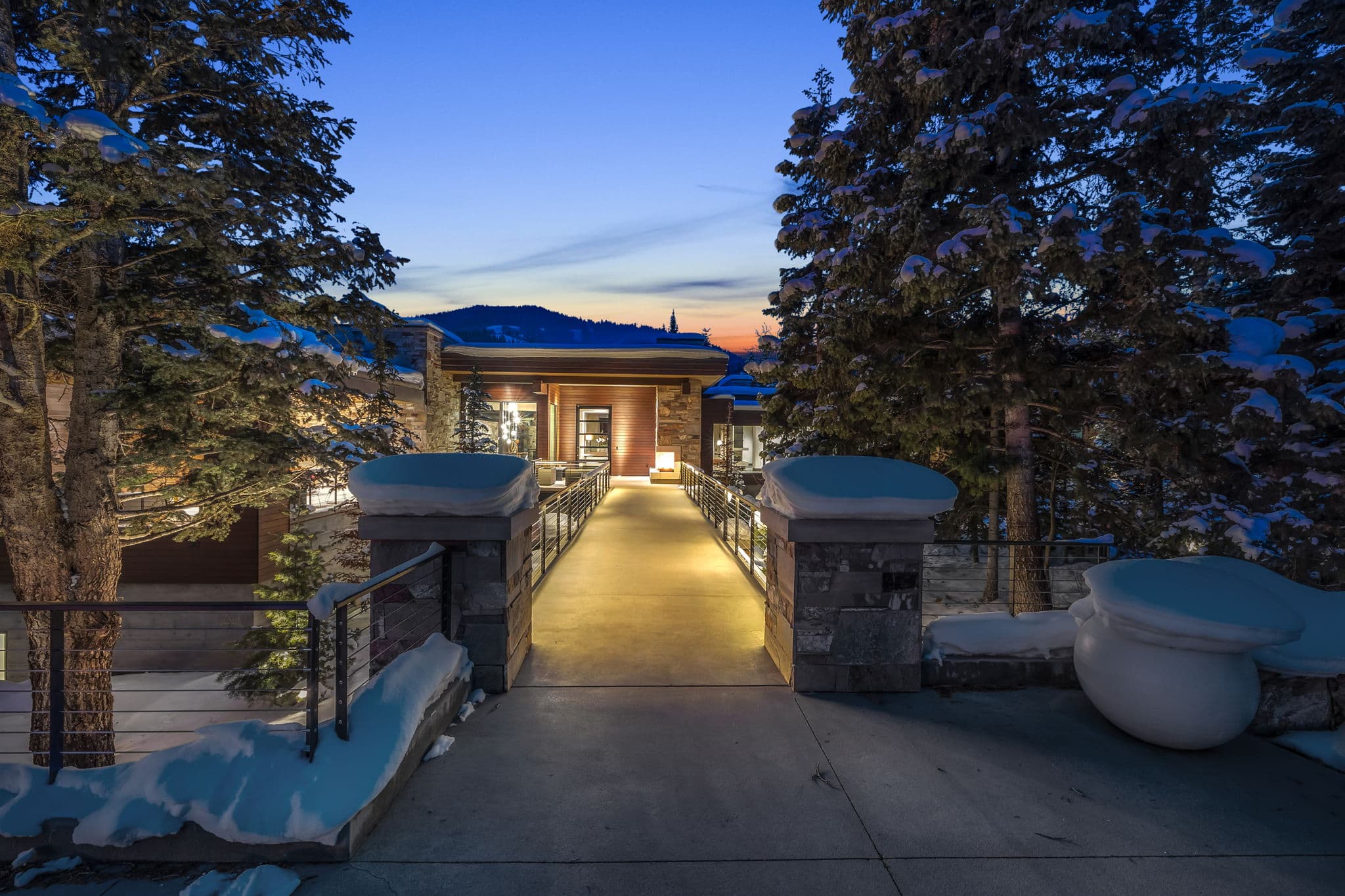 A White Pine Canyon Ranch luxury Park City vacation rental with a grand, snowy entrance.