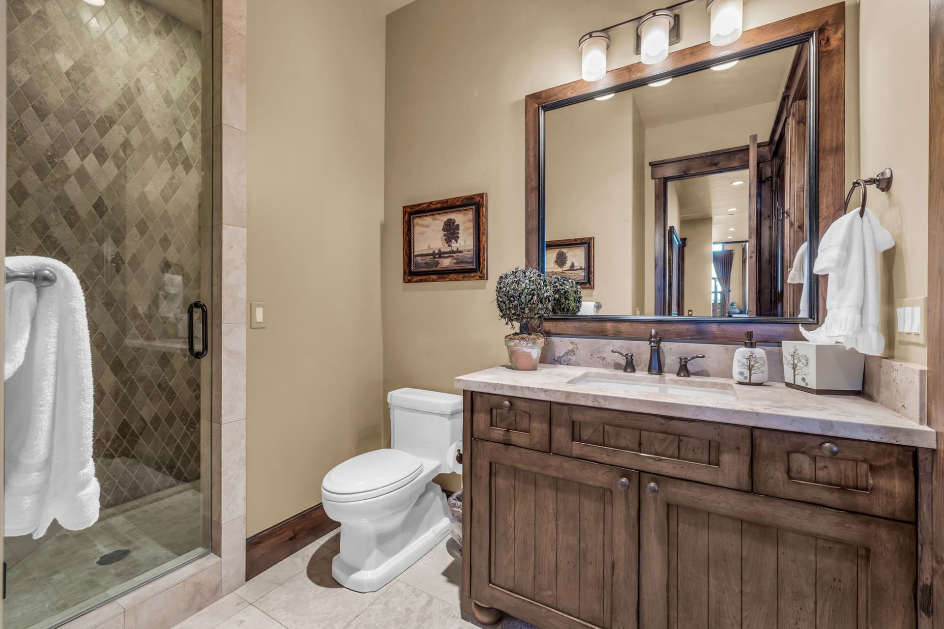 Bathroom in Morning Star at Deer Valley with toilet, sink, mirror and shower.