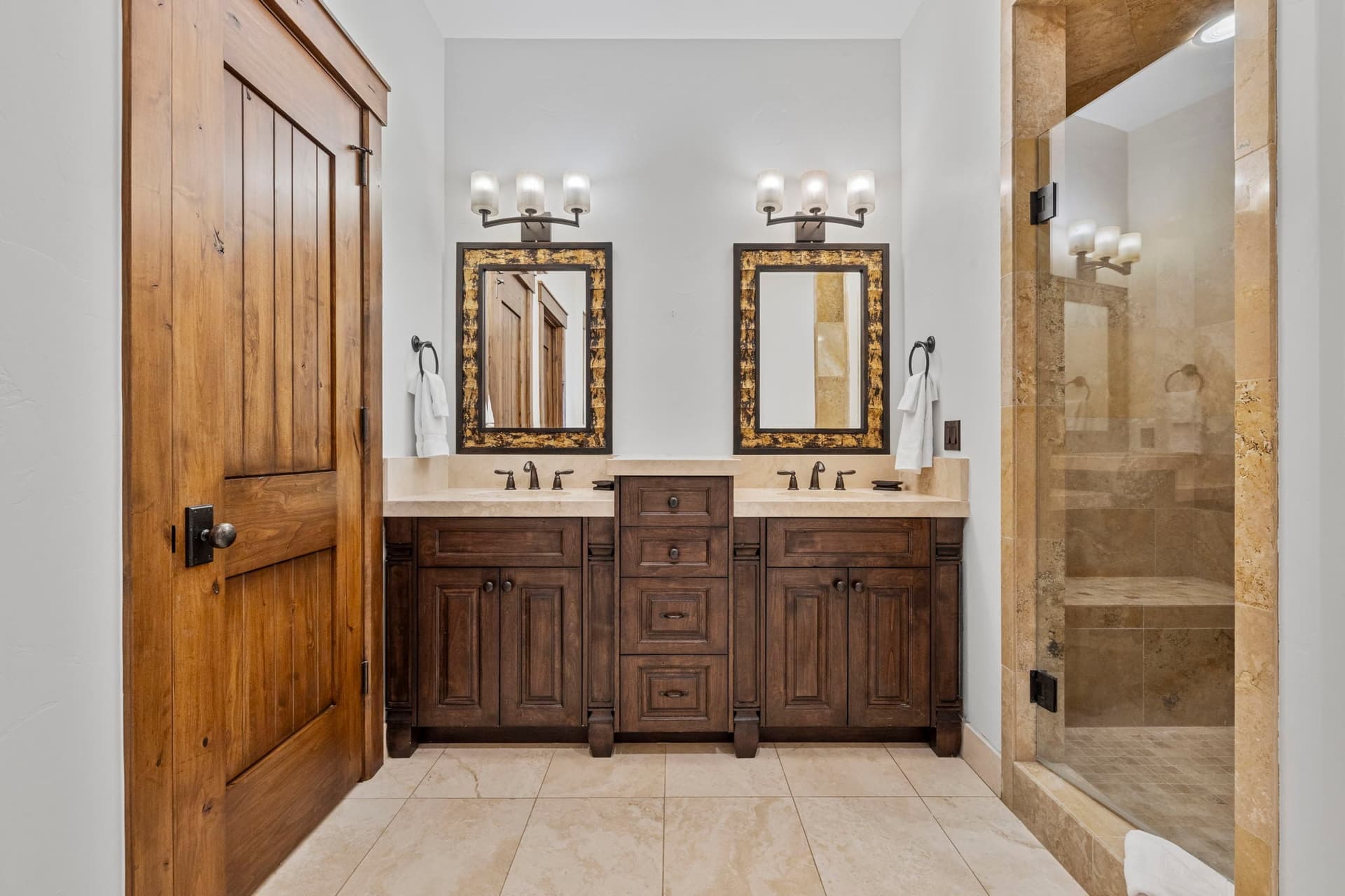 guest bathroom with dual vanities and luxurious cabinetry