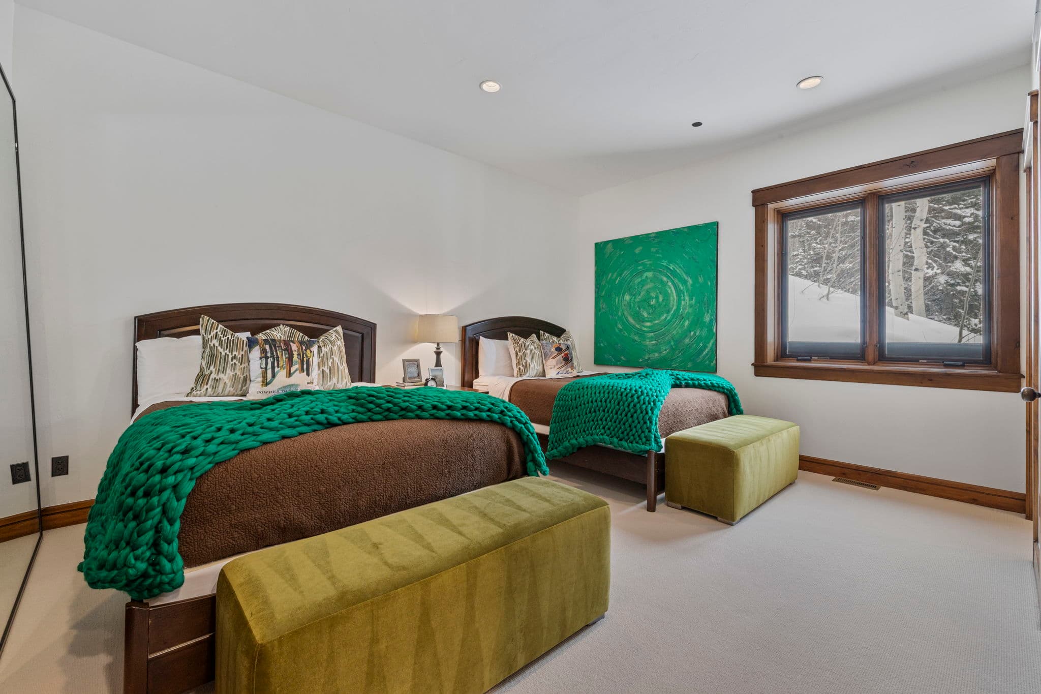 guest suite with two beds and a view of the slopes