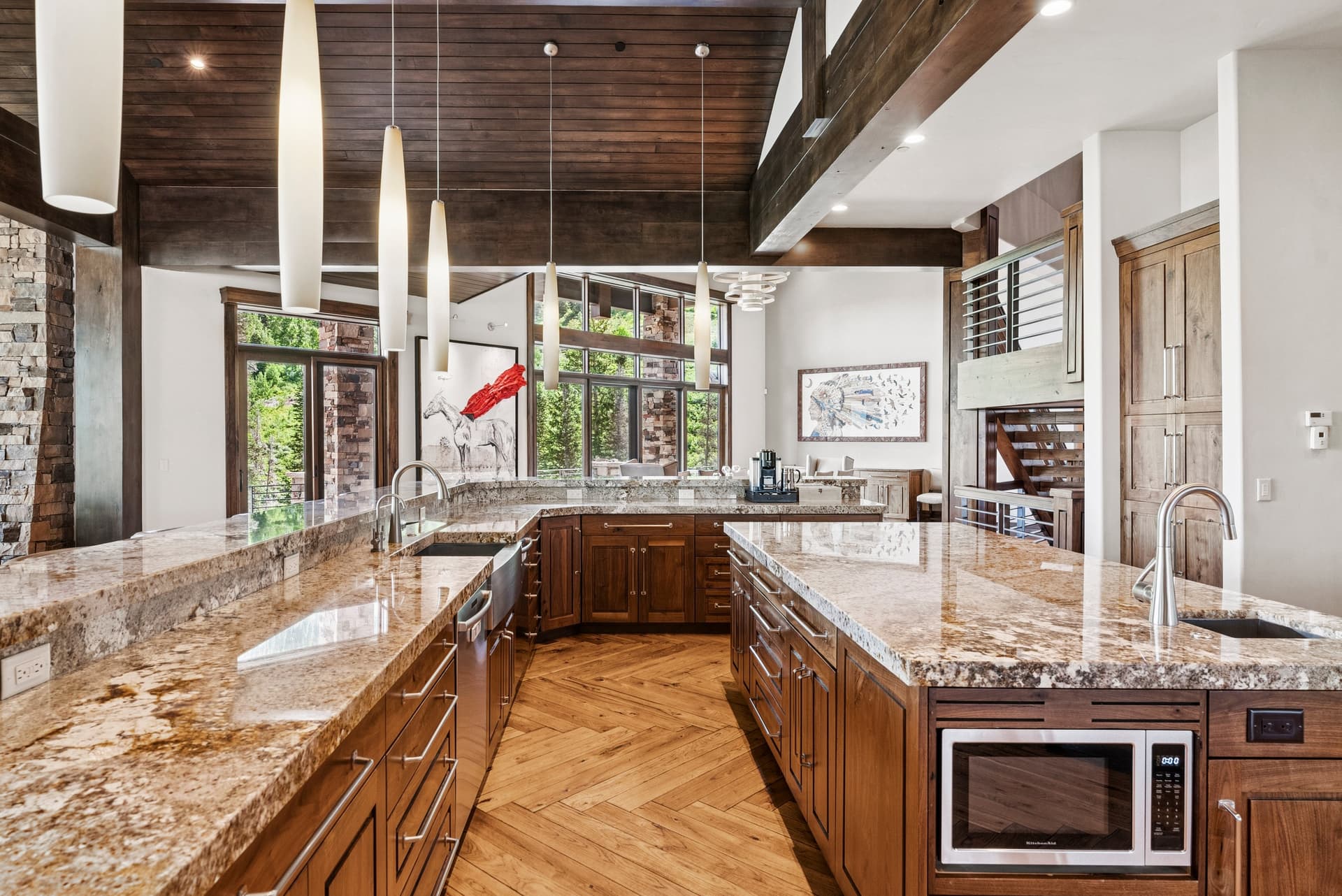large spacious kitchen with long island, granite countertops, and designer appliances