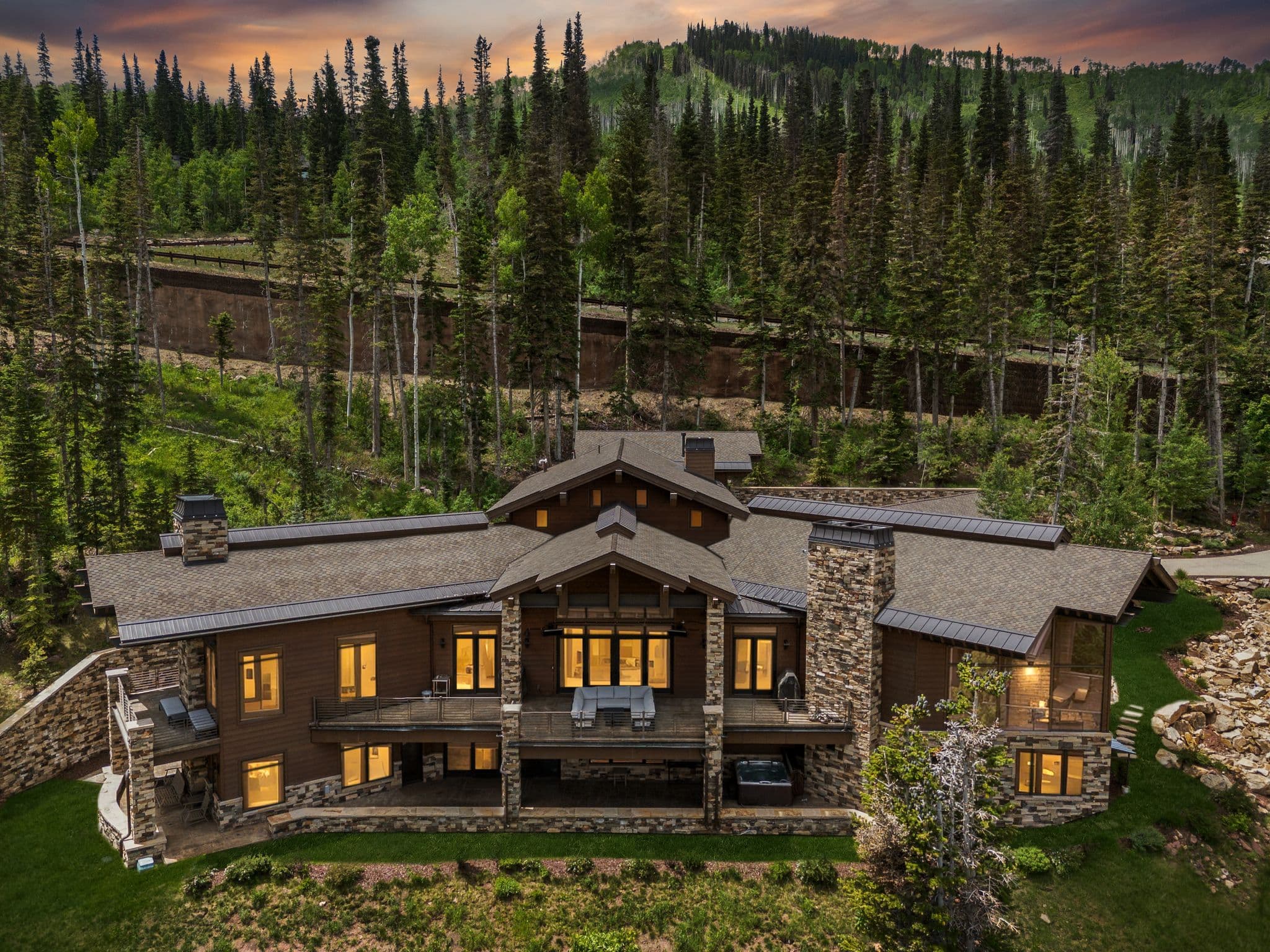 Image of Grandview, a luxury ski-in/ski-out vacation rental with the mountains in the background and a glowing sunset